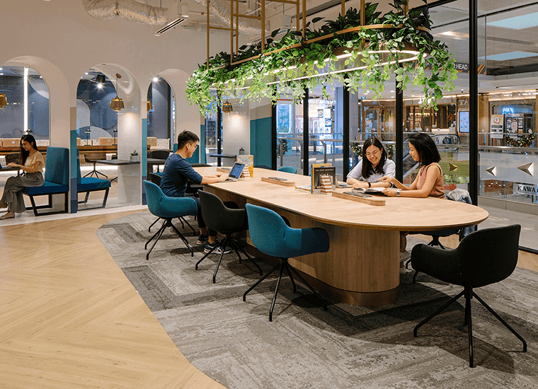 JustCo coworking space work area with desks and modern seating