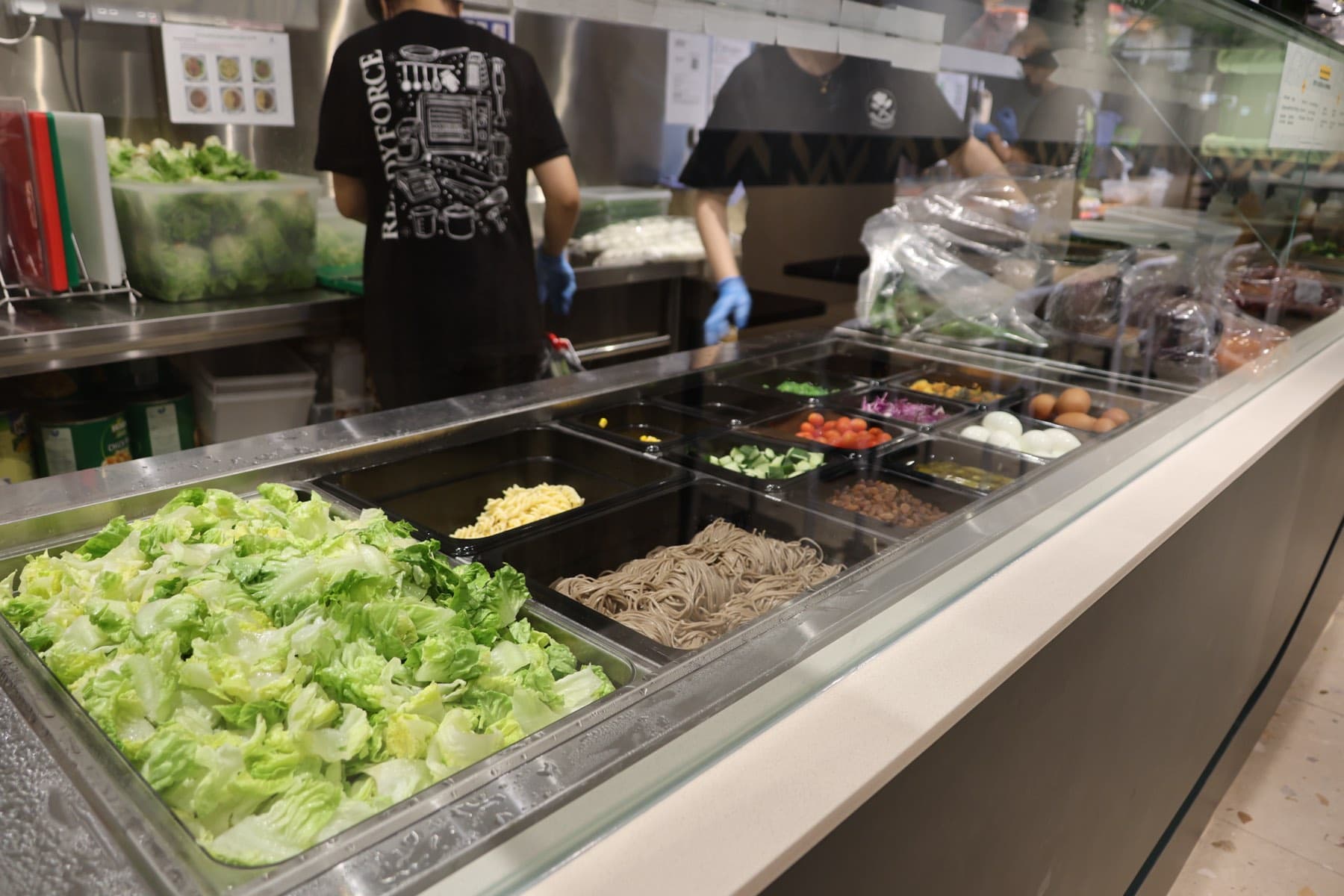 Readyforce crew in branded tees working in the Supergreen kitchen