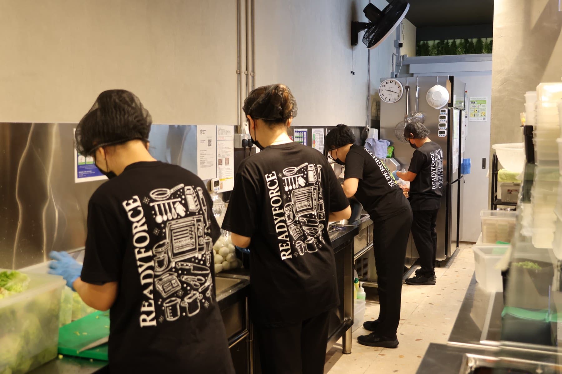 Readyforce crew preparing ingredients along the back-of-house prep line